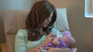 Ashley and two-month-old daughter, Paisley, in their California home.  Image courtesy of CNN.